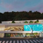 An artificial image of a building with a small garden on the top.