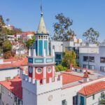 A view at a building in a town all in white and red exteriors